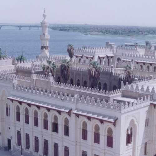 White architectural building with a minaret near the Nile River in Assiut, Egypt.