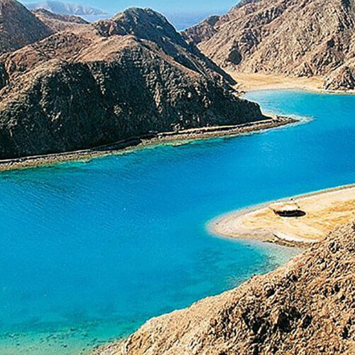 Aerial view of the stunning blue waters surrounded by rugged mountains at Fjord Bay.